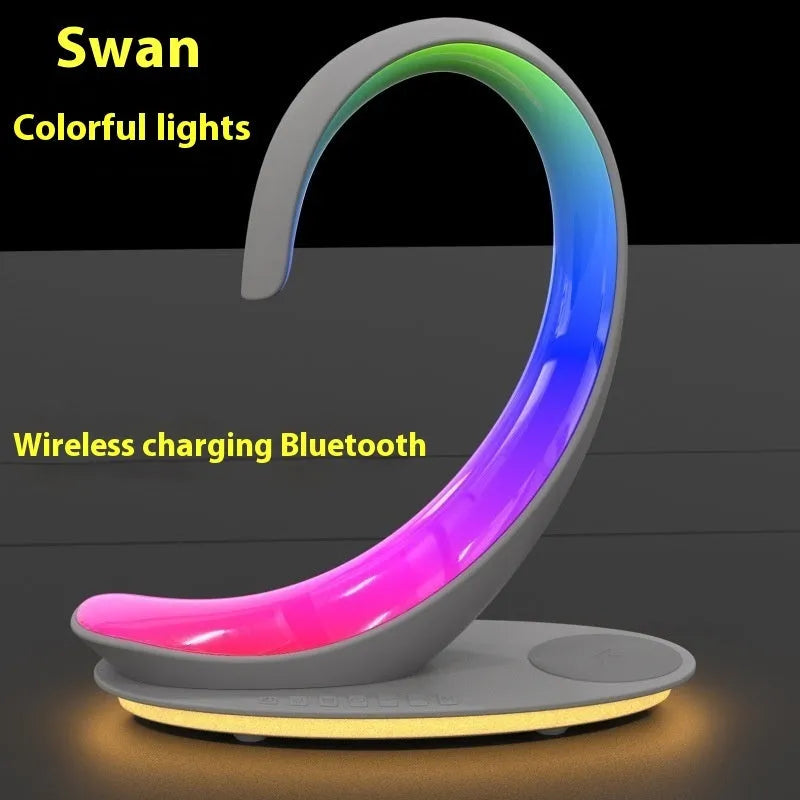 White swan shaped desktop lamp with wireless charging pad, Bluetooth speaker, and colourful LED lighting
