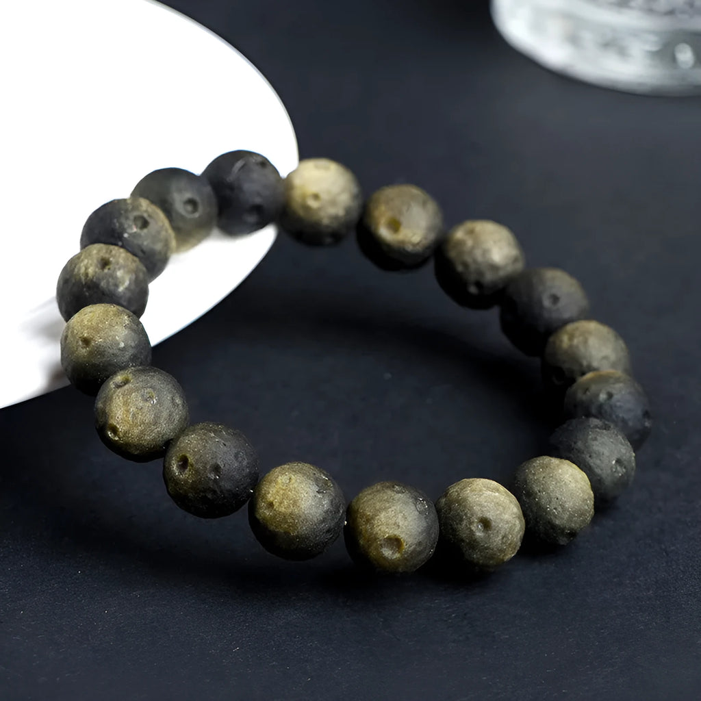 Obsidian crater ball bracelet with grinding texture in silver or golden meteorite colours