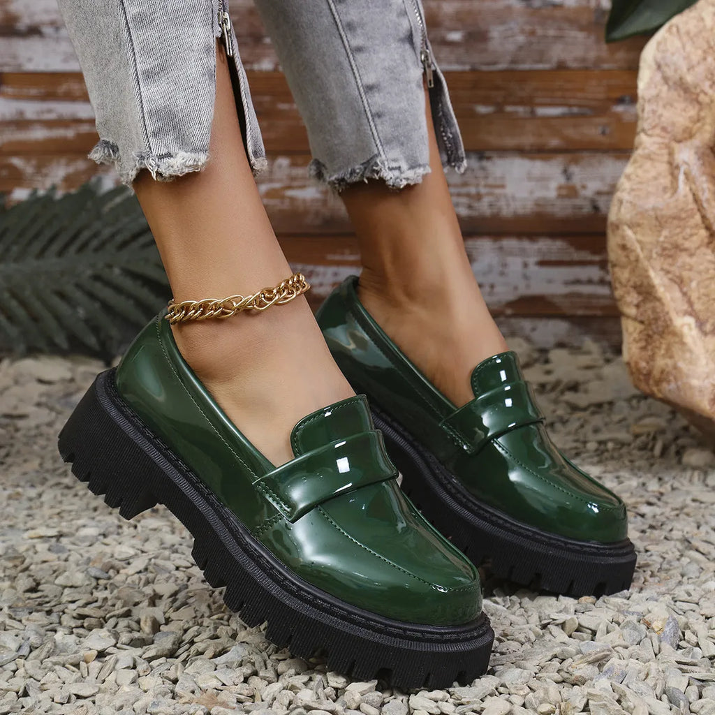 Plus size black chunky heel loafers with a thick rubber sole and slip-on design.