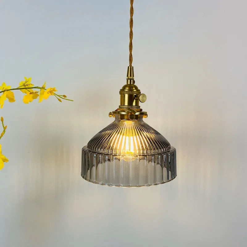 Brass and glass ceiling chandelier light with an adjustable suspension wire.