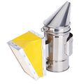 Portable stainless steel beekeeping smoker with leather bellows on a wooden surface
