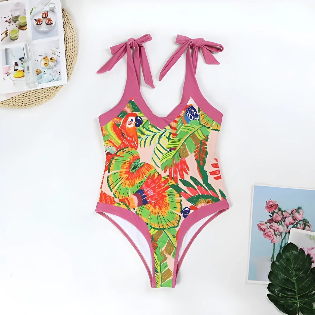 Pink floral print one-piece swimsuit with V-neck, covered belly design, and attached thin skirt