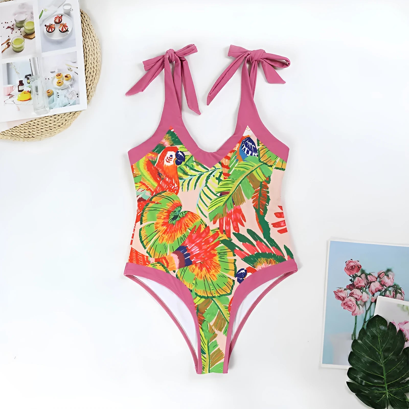 Pink floral print one-piece swimsuit with V-neck, covered belly design, and attached thin skirt