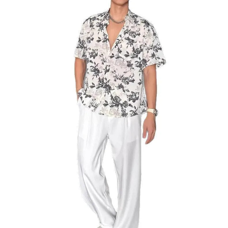 Men's loose black floral print short sleeve casual shirt on a hanger