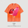 A loose-fitting heavy washed cotton t-shirt with a cartoon print, shown in a selection of available colours.
