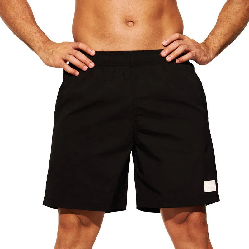 Men's solid colour quick-dry nylon sports shorts with straight leg opening.