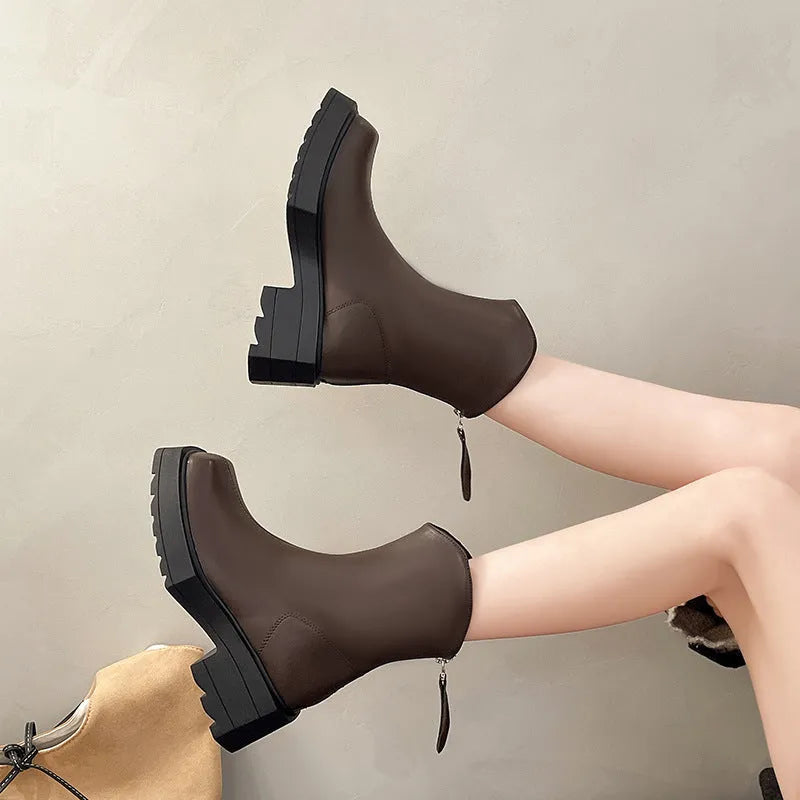 Black women's platform Martin boots with a square toe and back zipper on a neutral background.