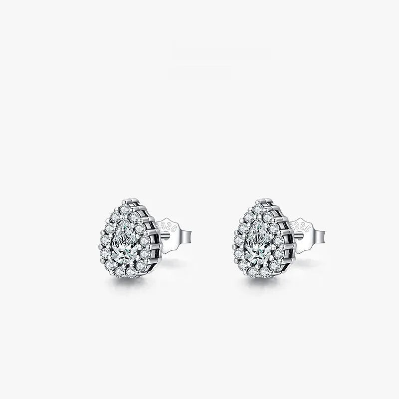 Close-up of a pair of women's silver water drop shaped stud earrings on a plain background.