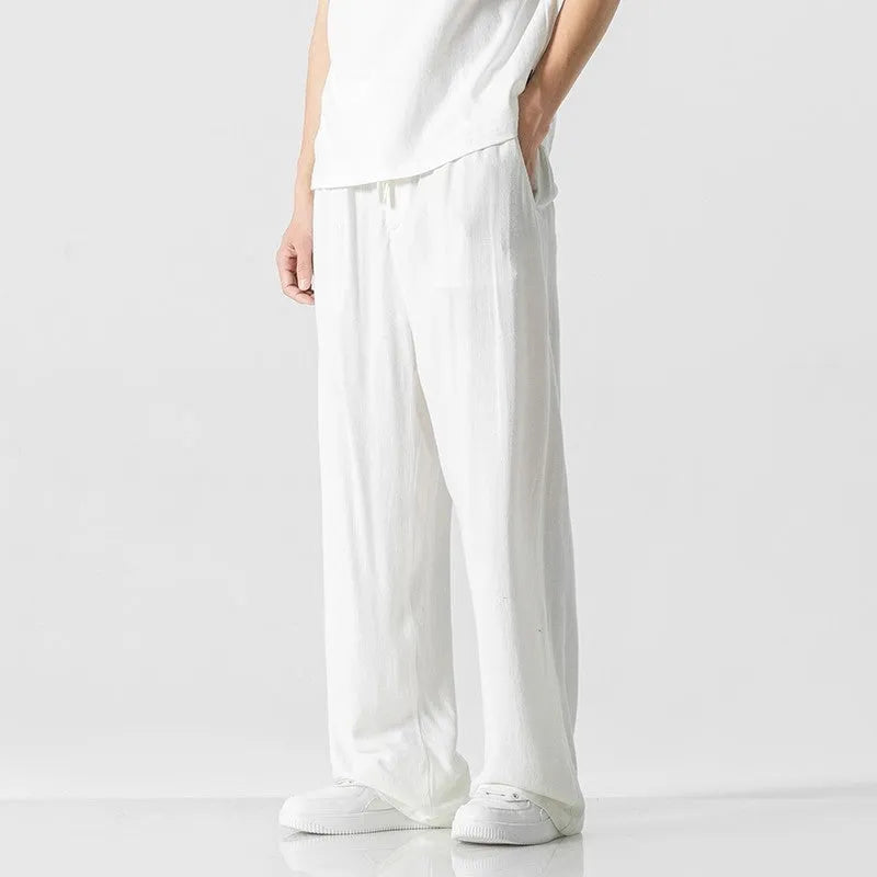 Men's beige bamboo fibre linen trousers with a straight leg, cropped length, and drawstring waist on a mid-rise.