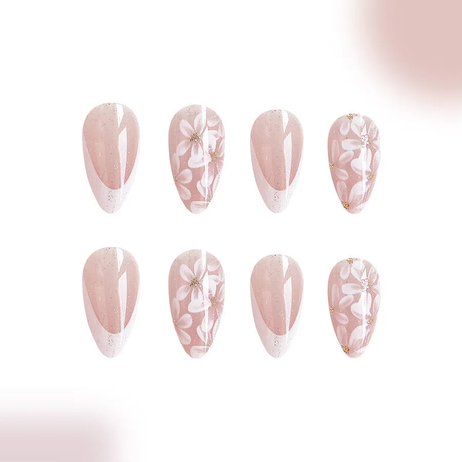 Glossy almond shaped press-on nails with French style white tips and glitter powder floral design in C625 pattern