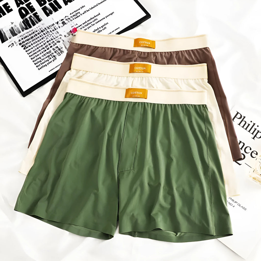 Pack of three men's solid colour loose fit nylon ice silk underwear in mid-waist style.