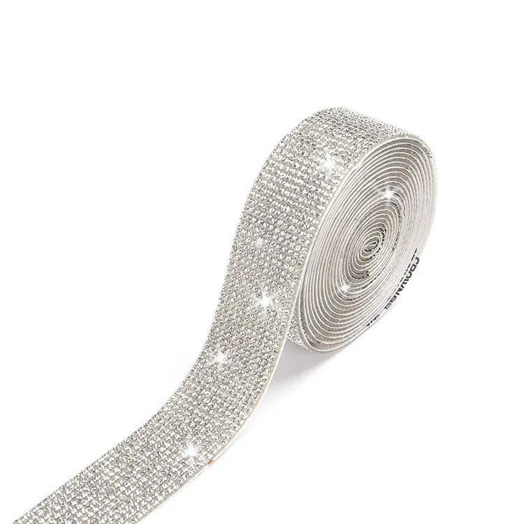 Self-adhesive water drill strip for clothing decoration in white and AB colour on a fabric background.