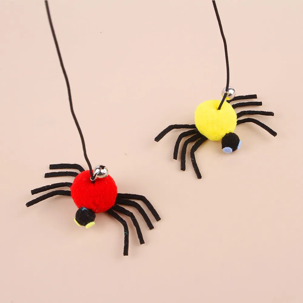 Red and yellow hanging door cat toy with elastic rope, feather, bell, and spider attachments.