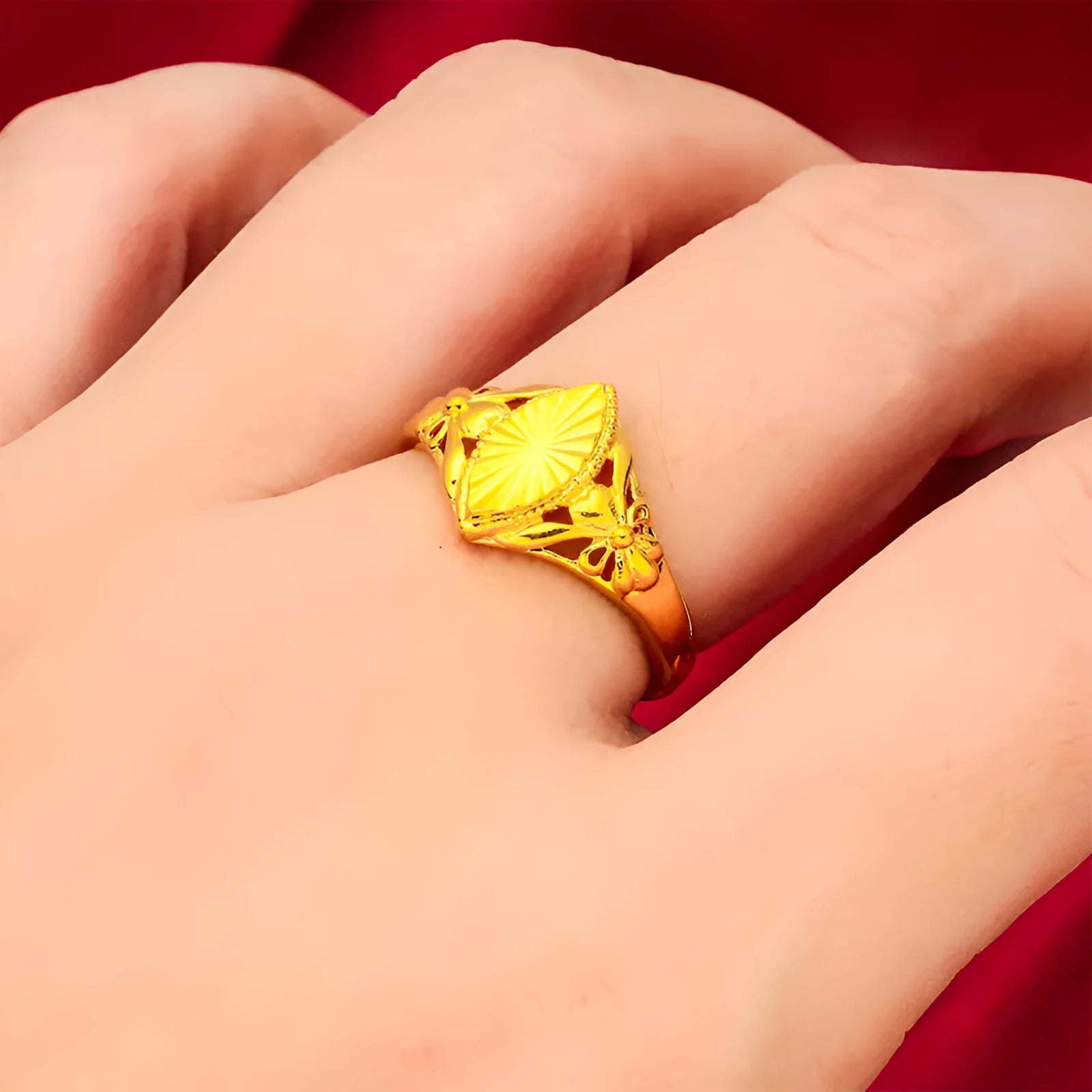 Gold coloured electroplated brass ring with a geometric open diamond flower design and textured details.