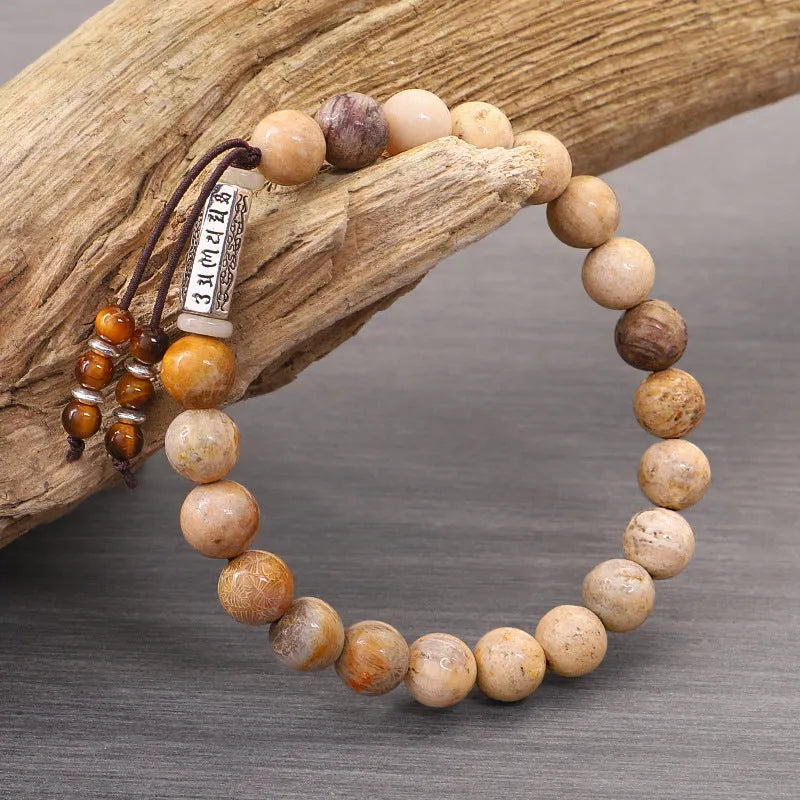 Original design handmade stone bead bracelet in natural wood colour on wrist.