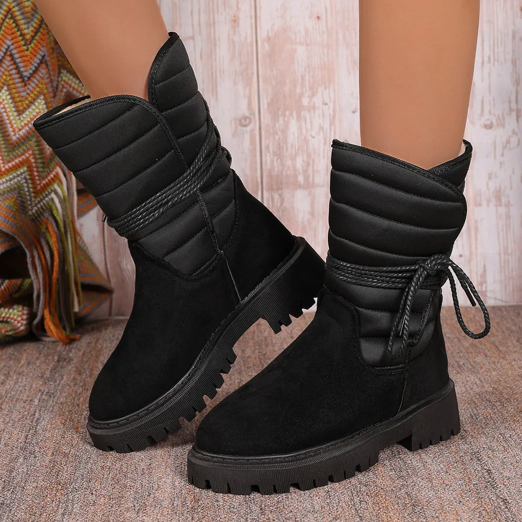 Women's black chunky heel snow boots with lace-up front and fleece lining on a white background.
