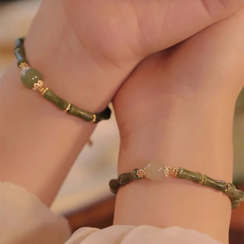 Women's simple geometric Hetian jade bracelet in dark green and light colour on a white background.
