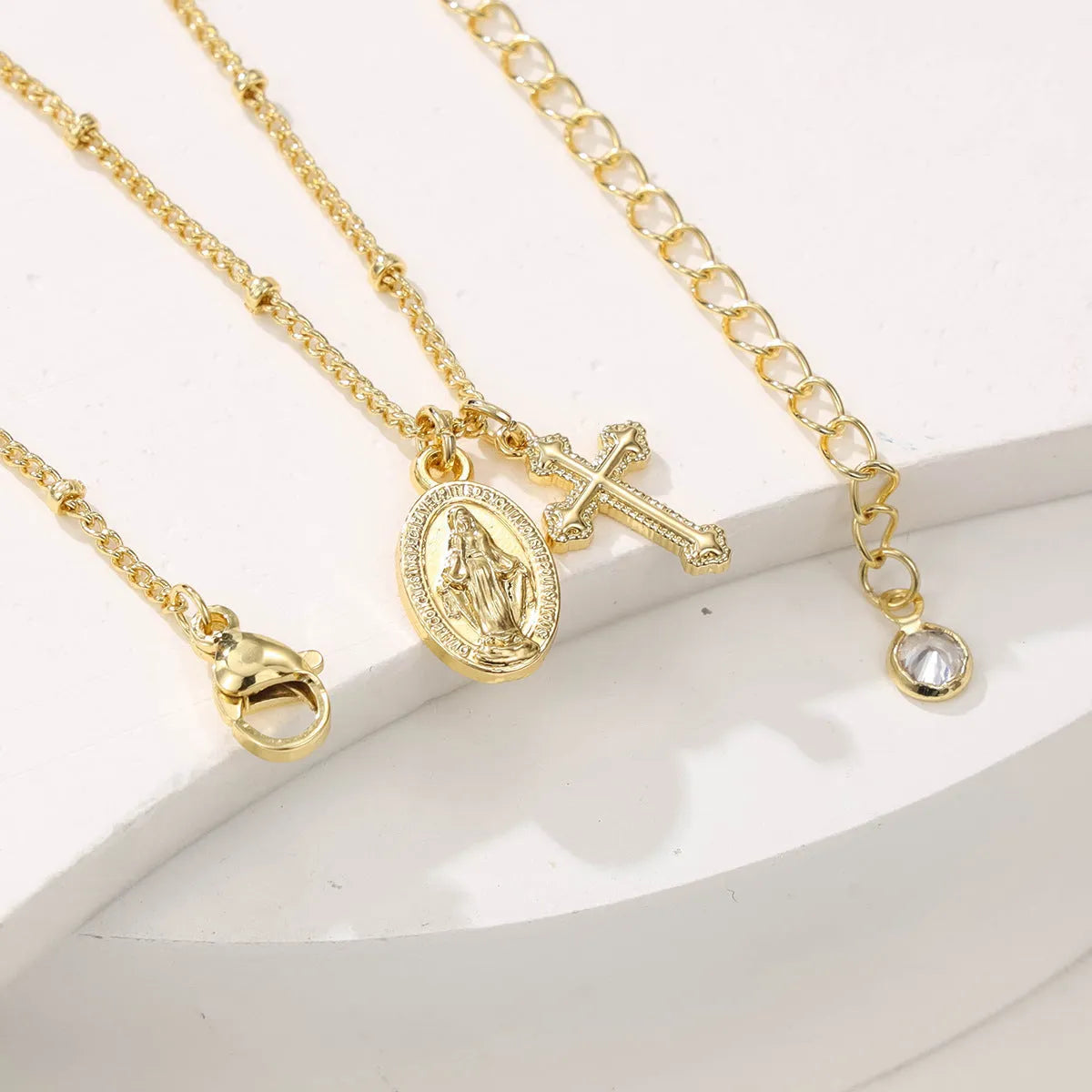 Gold Virgin Mary cross necklace with geometric pendant design for women