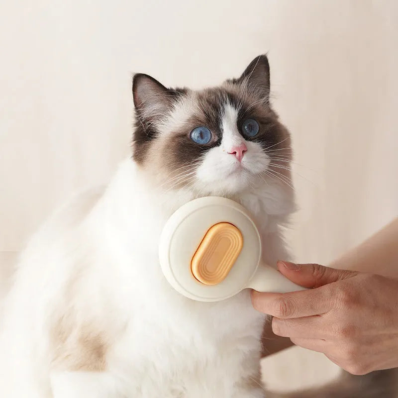 Green stainless steel cat grooming brush with non-slip handle for pet hair removal