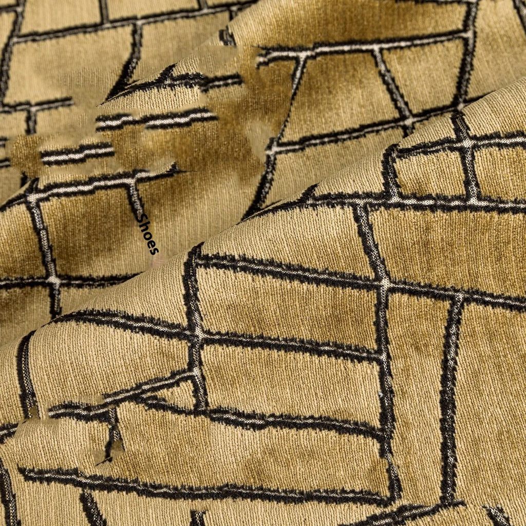 Gold geometric abstract pattern on a square polyester cushion cover with feather velvet pillow insert.