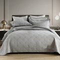 Pure cotton double-sided bed cover three-piece set in beige Damascus pattern on a bed.