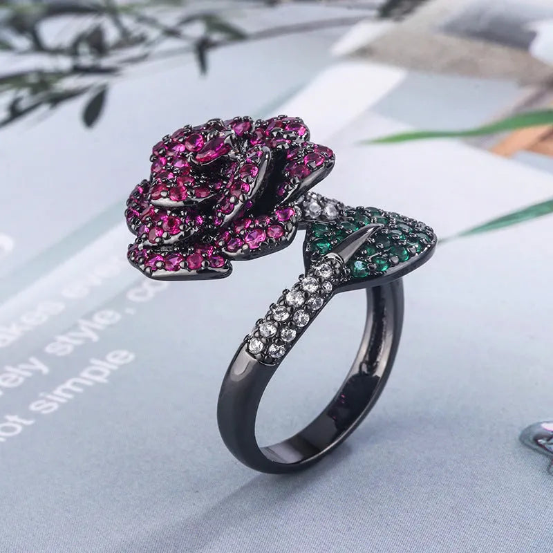 Gold-plated women's ring with a geometric black gold flower design and simulated red corundum detail.