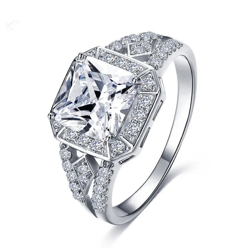 Geometric hollow design zircon ring in platinum-colour finish on copper, showing quadrilateral stone faceting