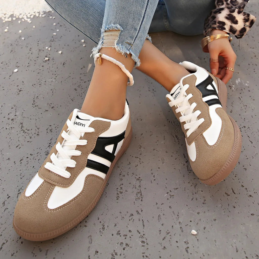 Women's retro colour matching lace-up jogging shoes in black with cross strap and low platform heel.