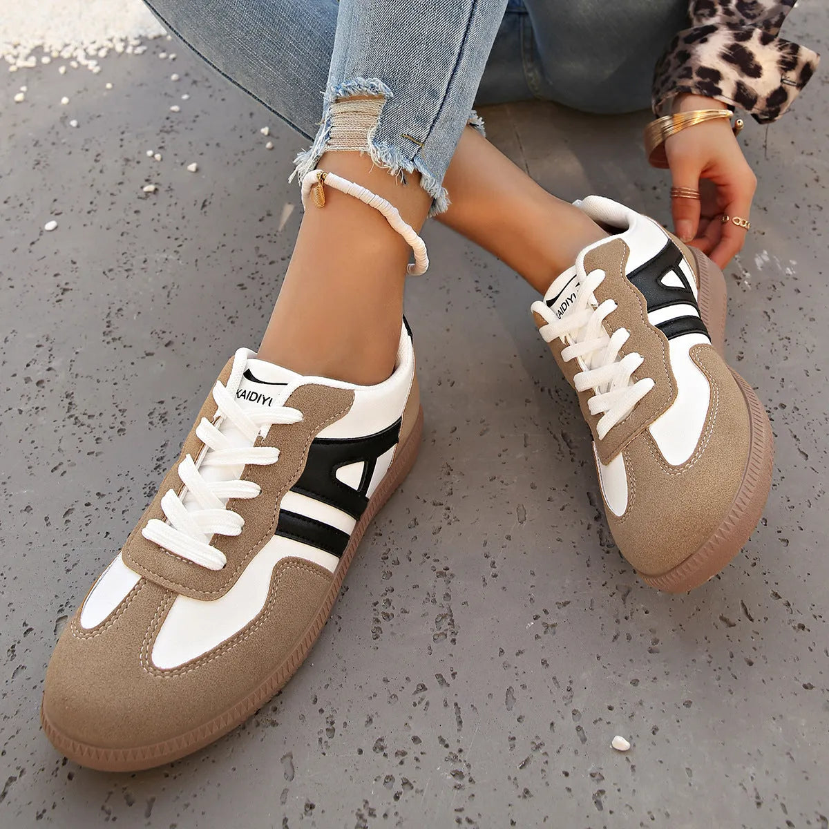 Women's retro colour matching lace-up jogging shoes in black with cross strap and low platform heel.