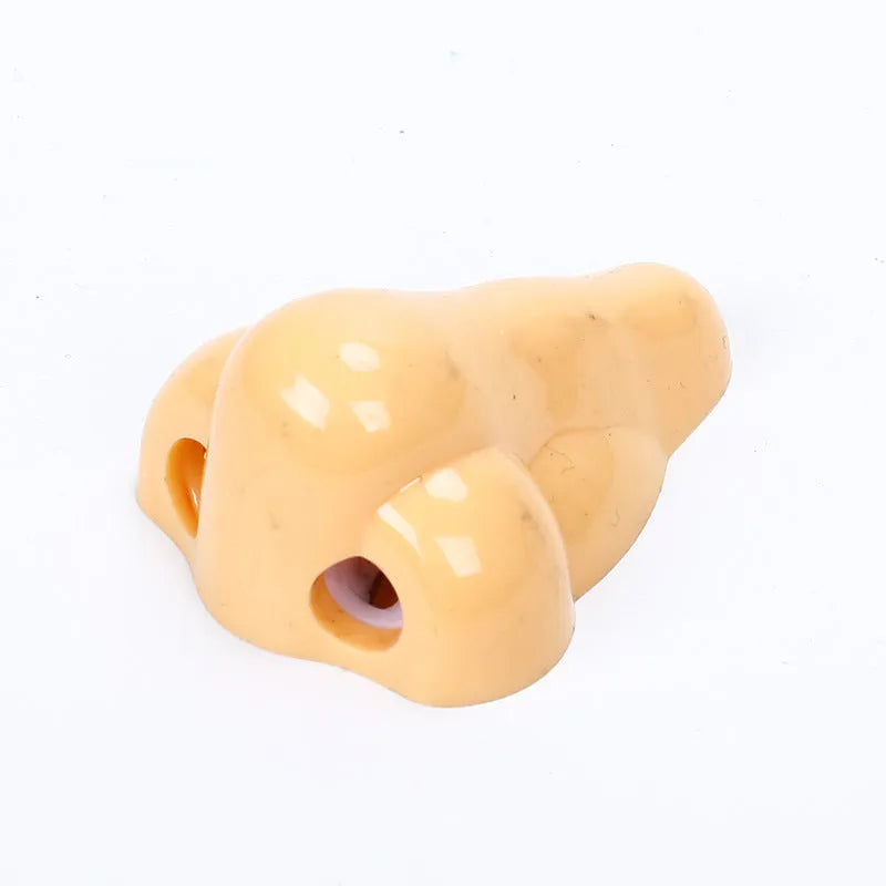 Flesh colour geometry plastic pencil sharpener with big nostril hole measuring 58x45x30mm