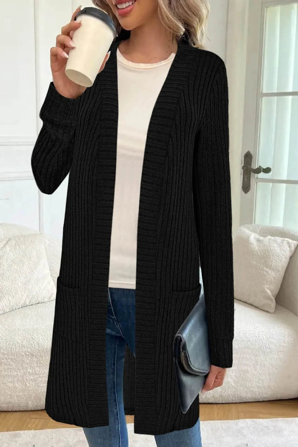 Long sleeve loose pocket knitted cardigan jacket in grey on a hanger.