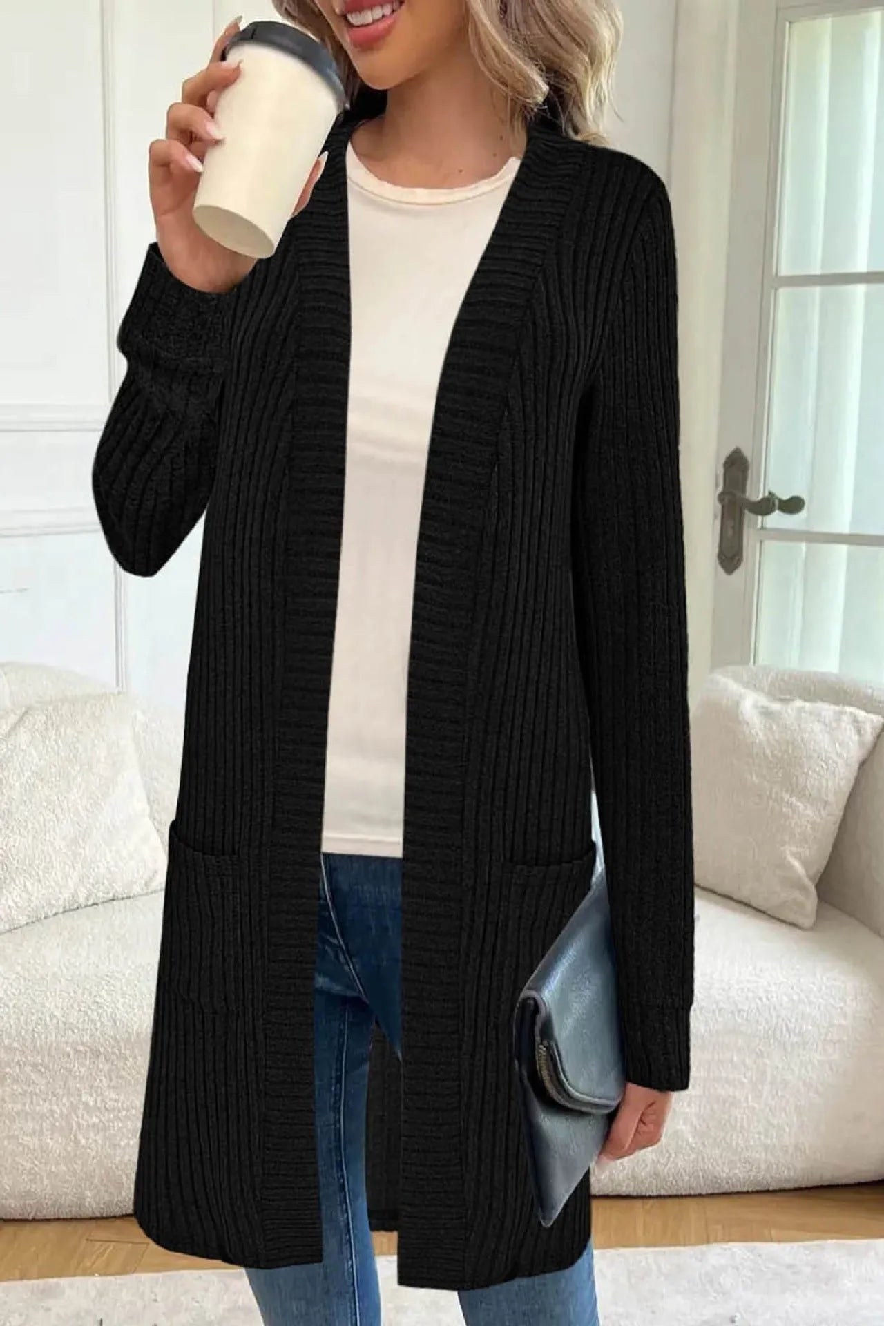 Long sleeve loose pocket knitted cardigan jacket in grey on a hanger.