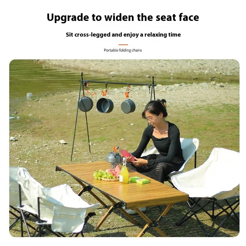 Portable folding recliner chair with steel frame and Oxford cloth seat in an outdoor setting.