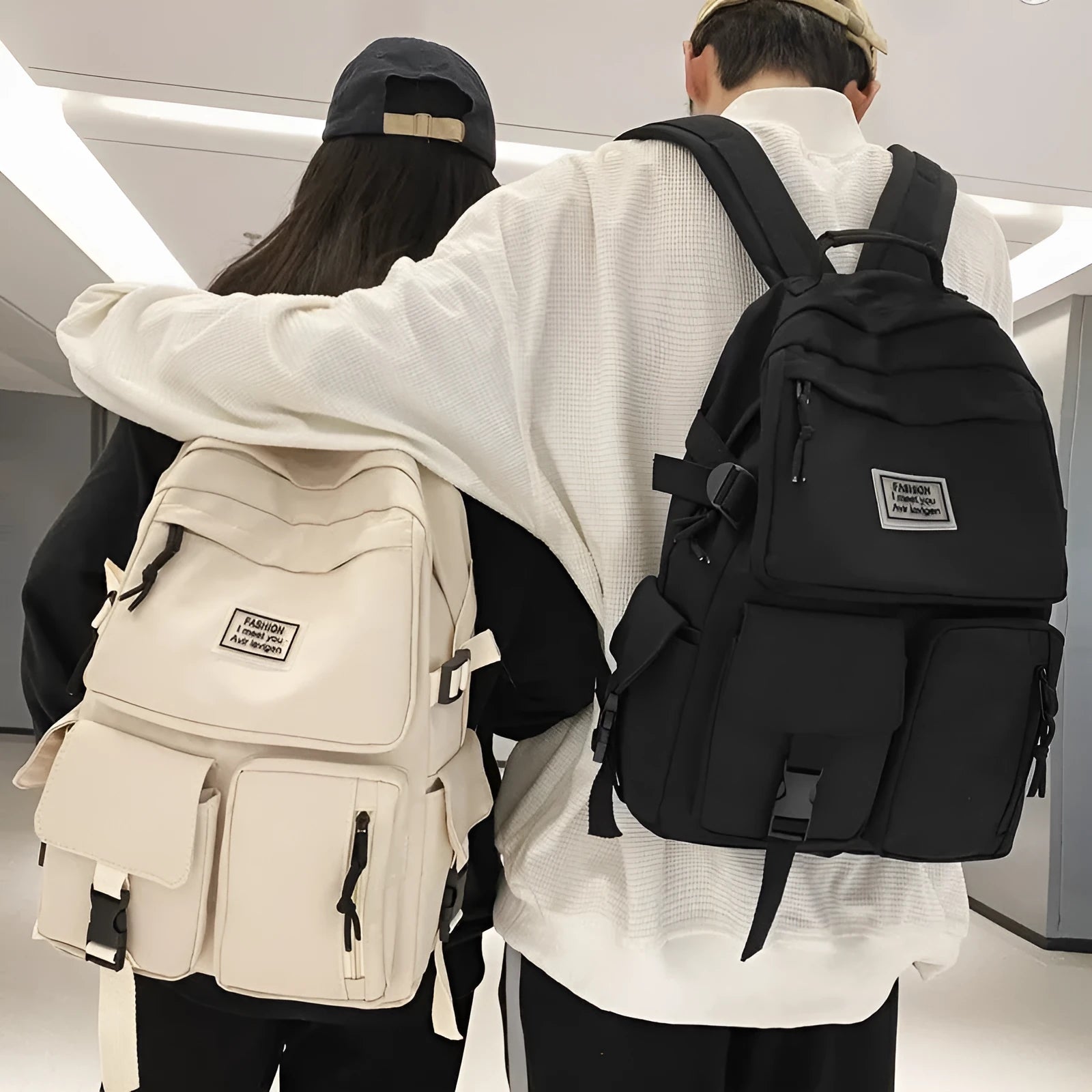 Black and white soft nylon student backpack with laptop compartment and external pockets.