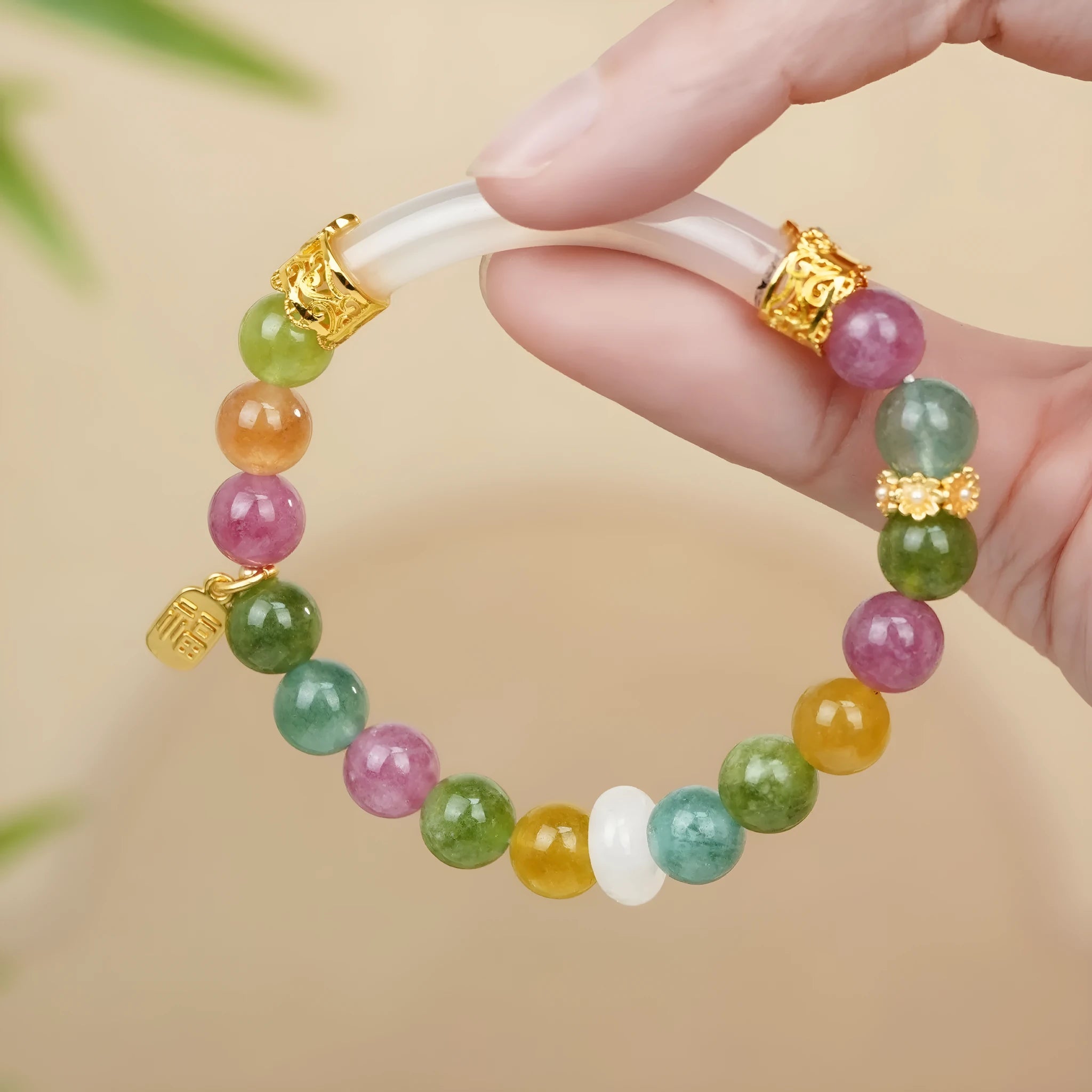 Natural rainbow coloured tourmaline gemstones on a women's jade pith half bracelet with electroplated finish.