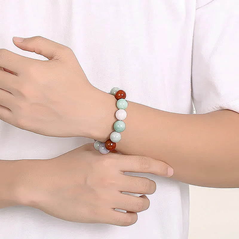 Women's natural Myanmar jade bracelet showing three colours in 13mm round bead design