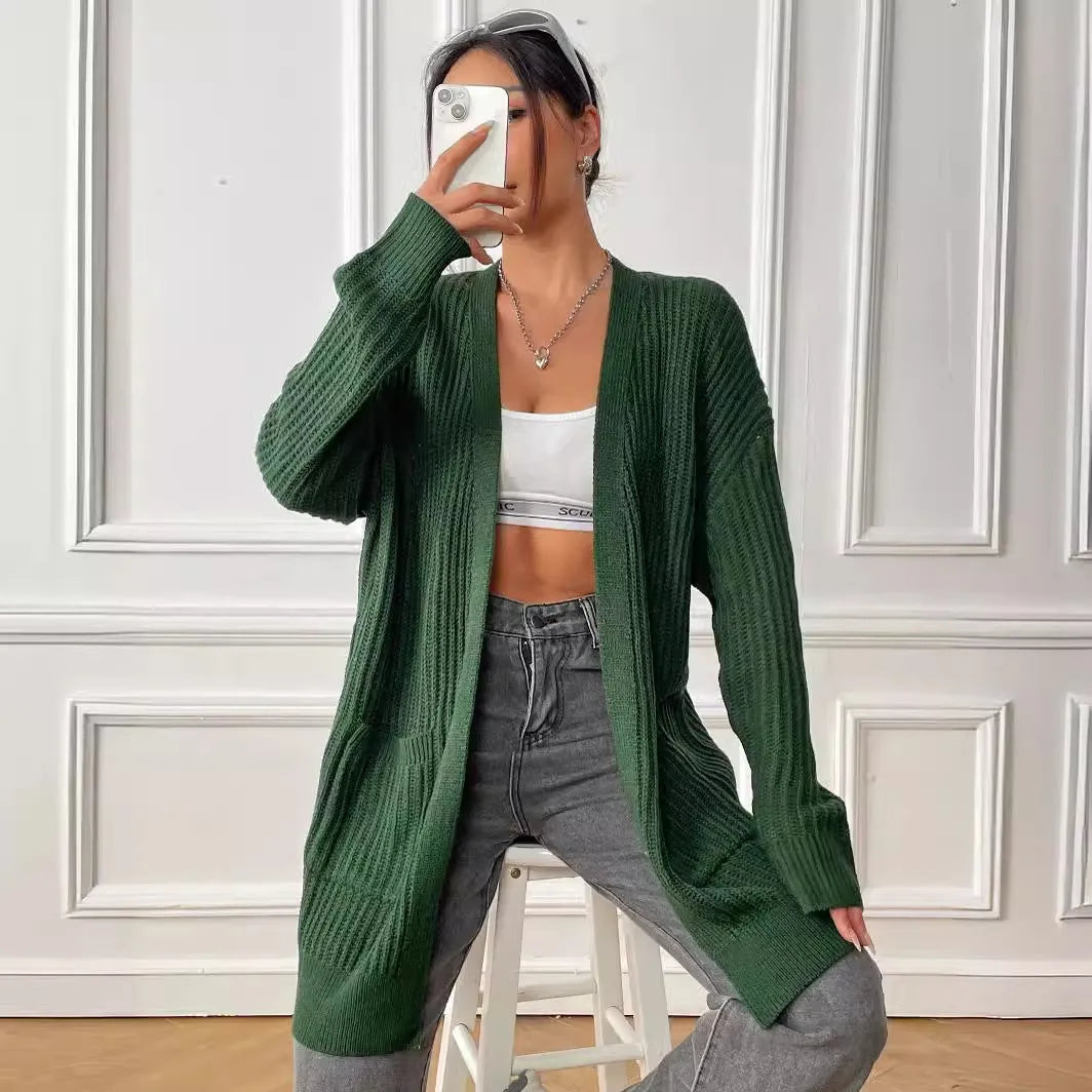 Women's dark green loose-fit acrylic cardigan with double pockets and long sleeves.