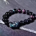Natural ice colour eye obsidian crystal bracelet on a wrist, showing bead size options.