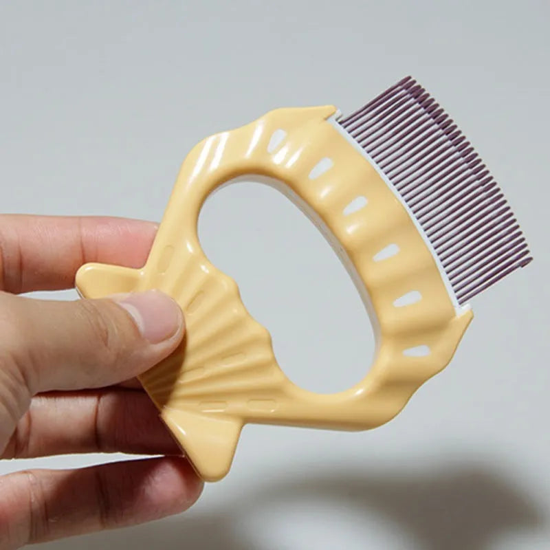 Green shell-shaped pet grooming comb with bent wire bristles and a plastic handle.