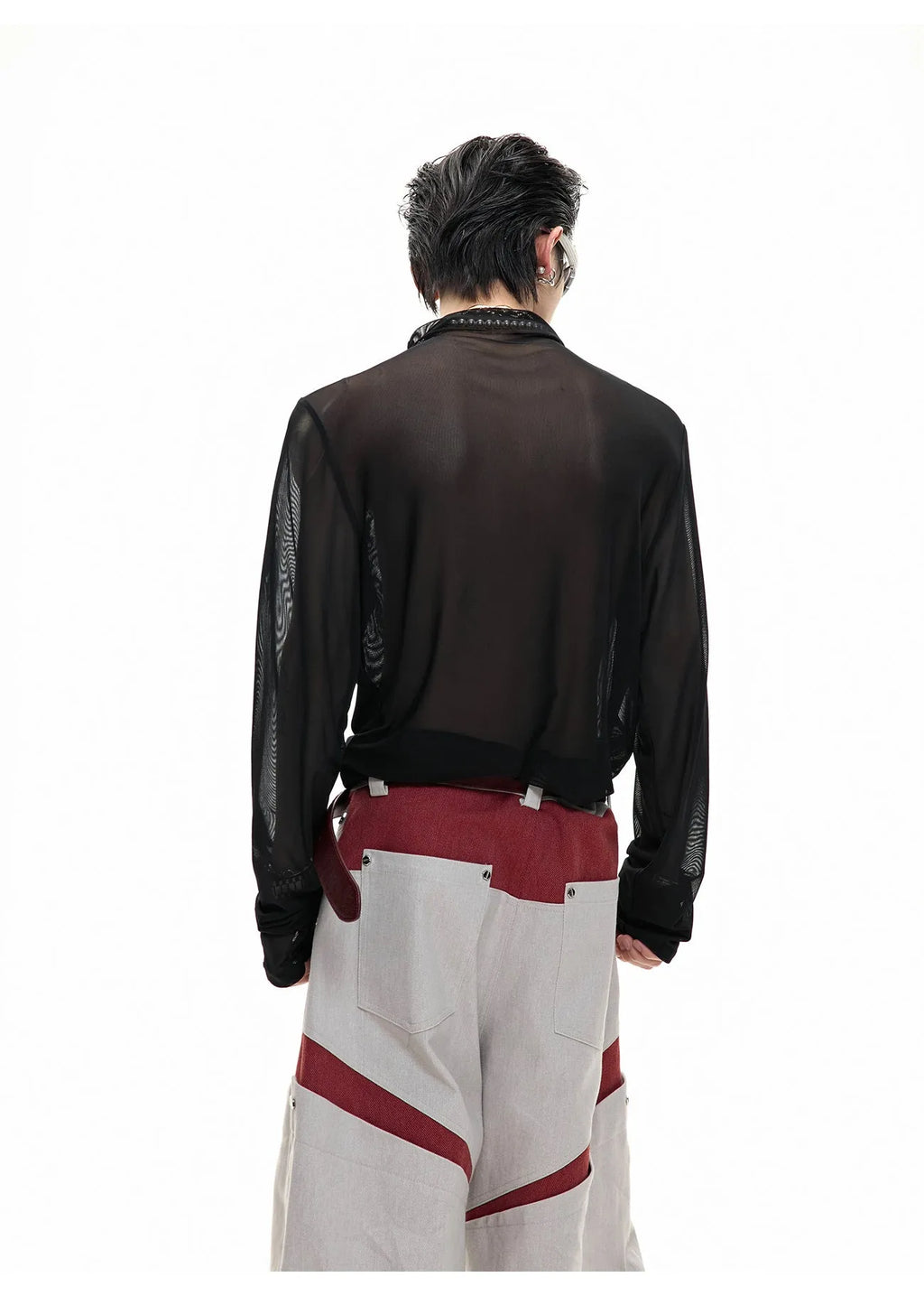Man wearing a black niche mesh slim-fit long sleeve shirt showing texture and fit.