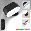 Oval-shaped cordless wall lamp with magnetic rotation and remote control in black or white finish
