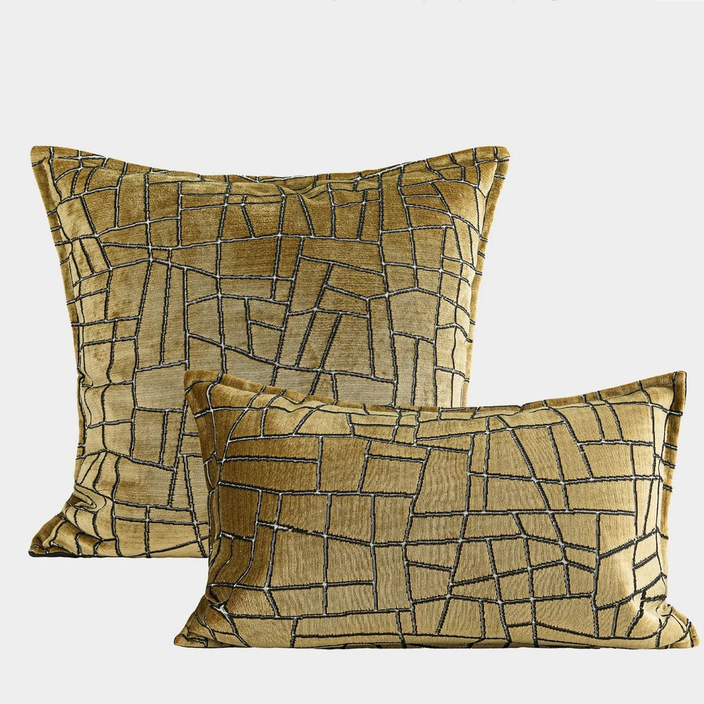 Gold geometric abstract pattern on a square polyester cushion cover with feather velvet pillow insert.
