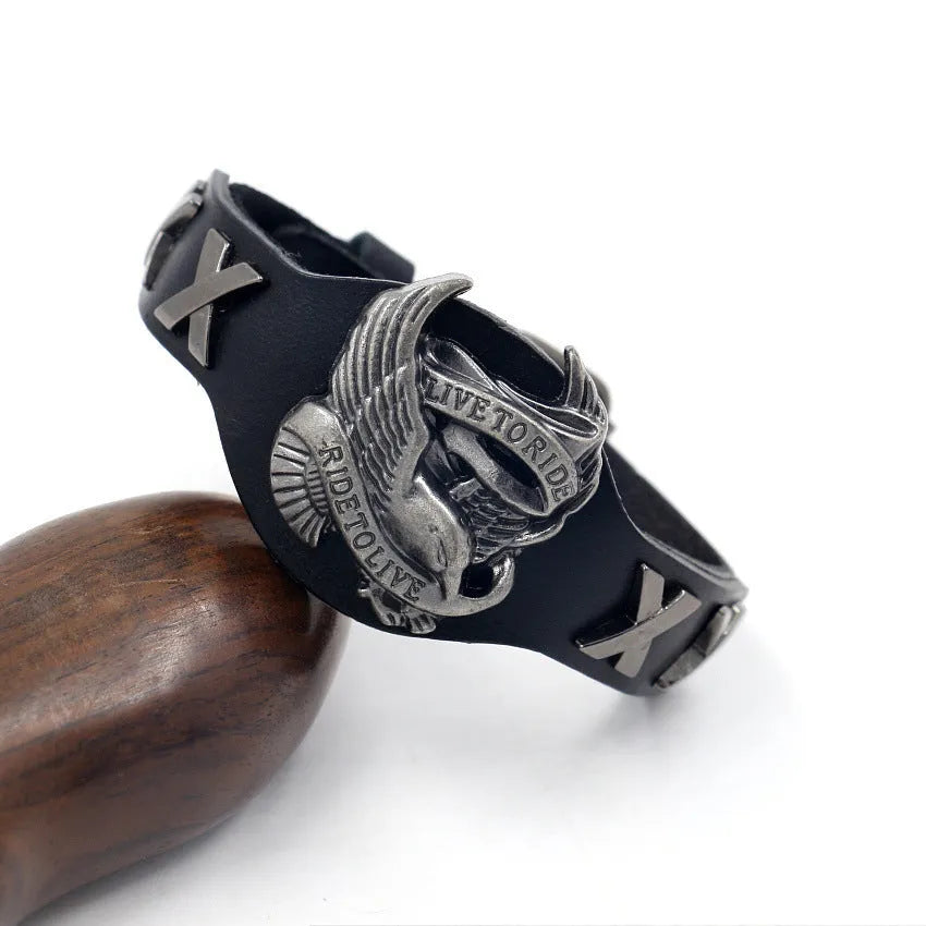 Black leather geometric bracelet with an alloy eagle clasp on a wrist.