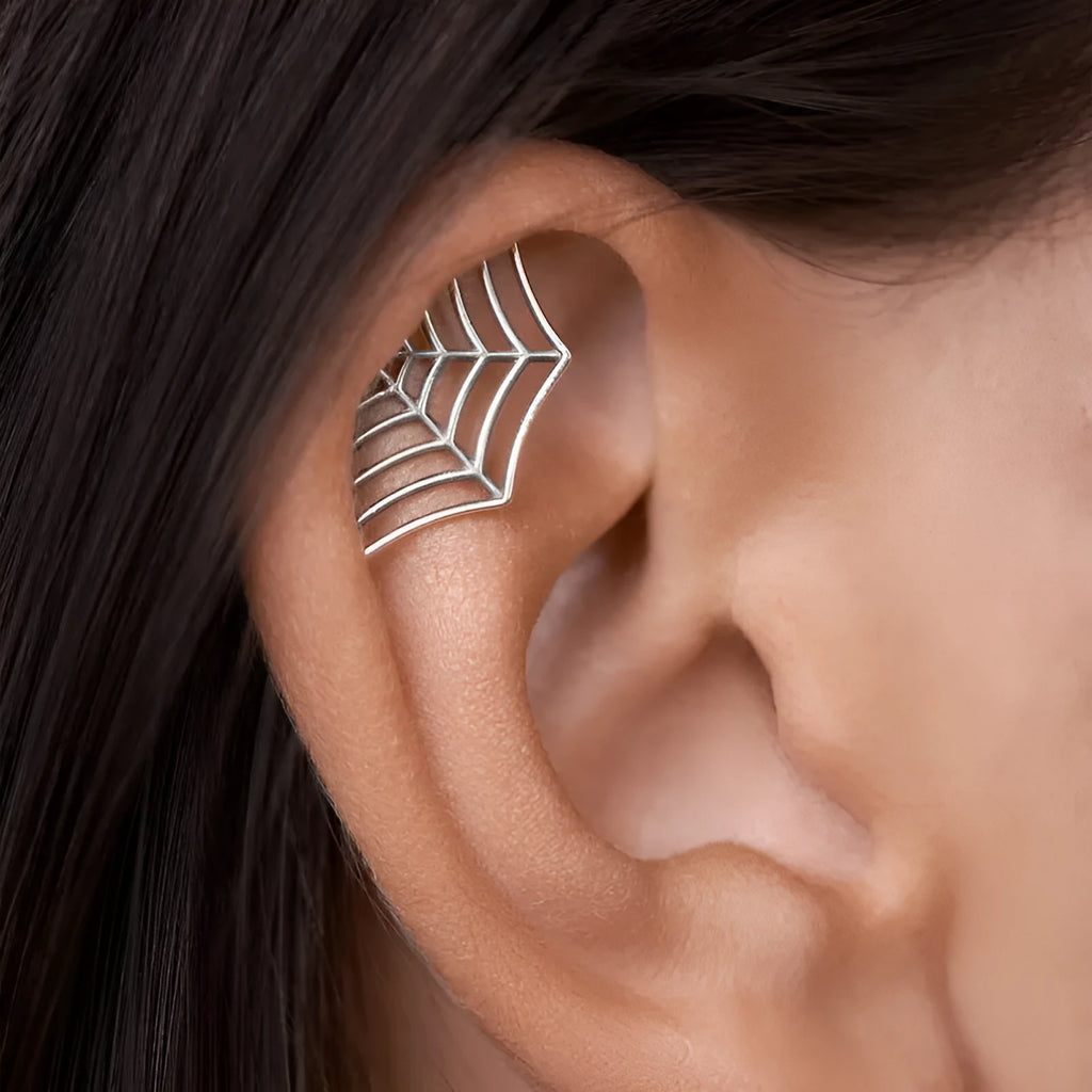 Gold and silver spider web stud earrings with geometric mesh pattern