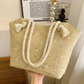 Large capacity straw shoulder bag with flap closure and phone pocket in khaki colour