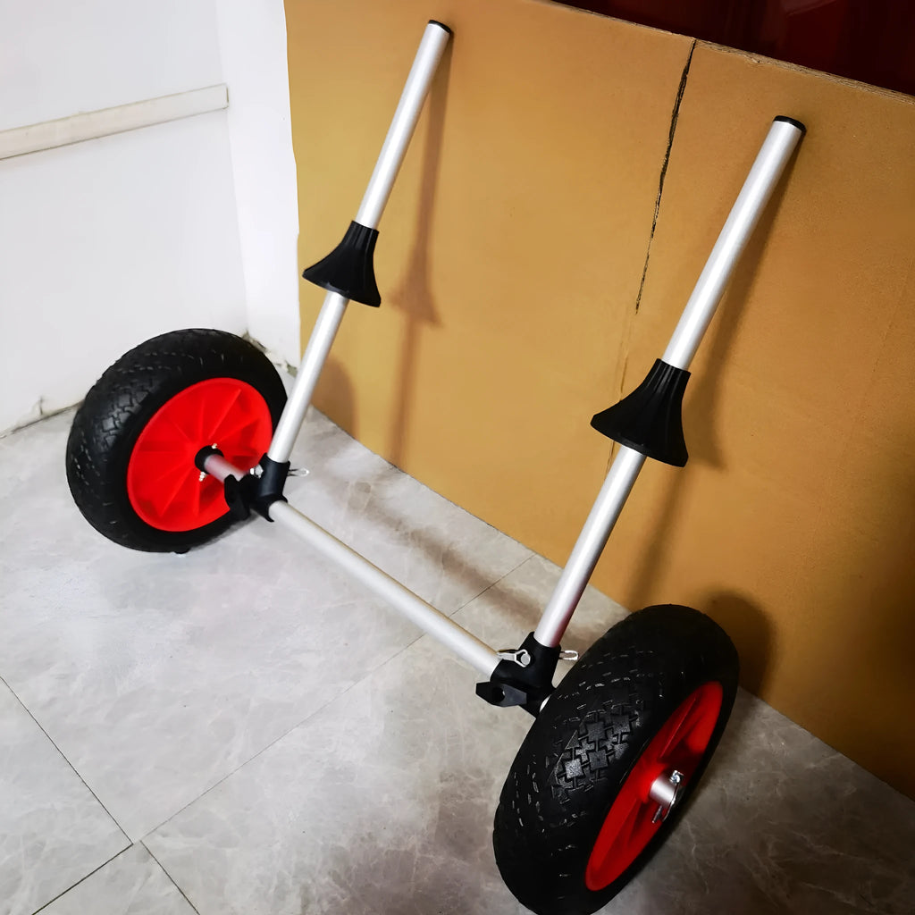 Foldable aluminium kayak beach trailer with large rubber wheels, shown assembled and ready to carry a kayak.