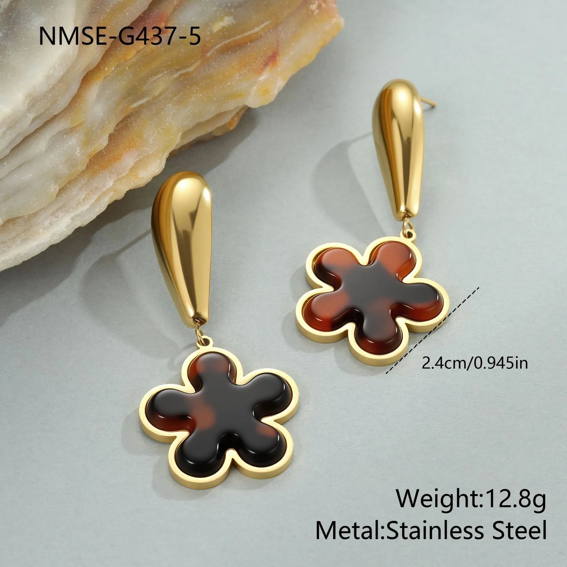 Close up of 18K gold plated stainless steel earrings featuring tortoiseshell resin in heart and flower geometric shapes for women.