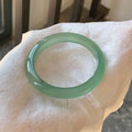 Natural agate wide tyre bracelet in pink stone showing band design and size options.