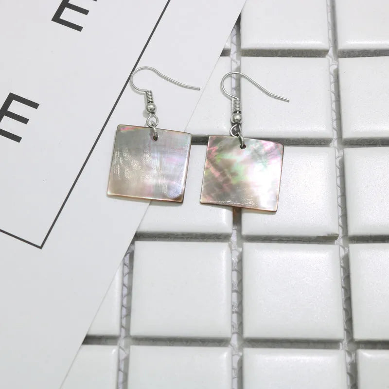 Geometric drop earrings made from natural shell in Square Panther or Rectangular Shell colour options.