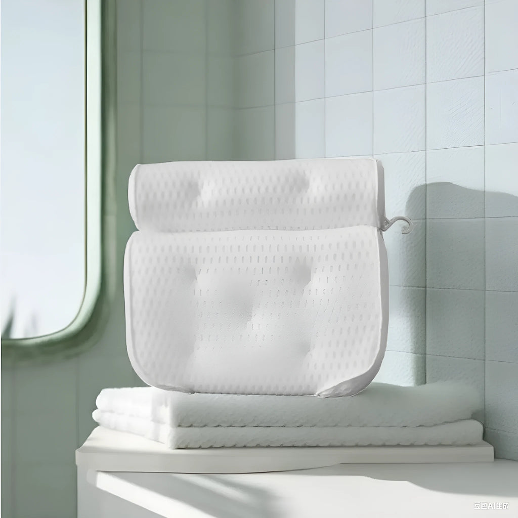 White 4D mesh bathtub pillow with suction cups on a clean bathtub surface.